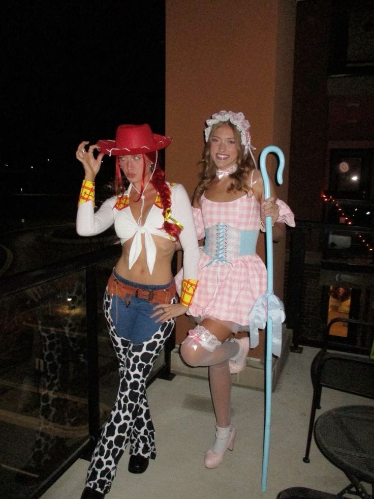 Best friend Toy Story costumes as Jessie and Bo Peep, with cow-print chaps, pink gingham, and a blue crook.