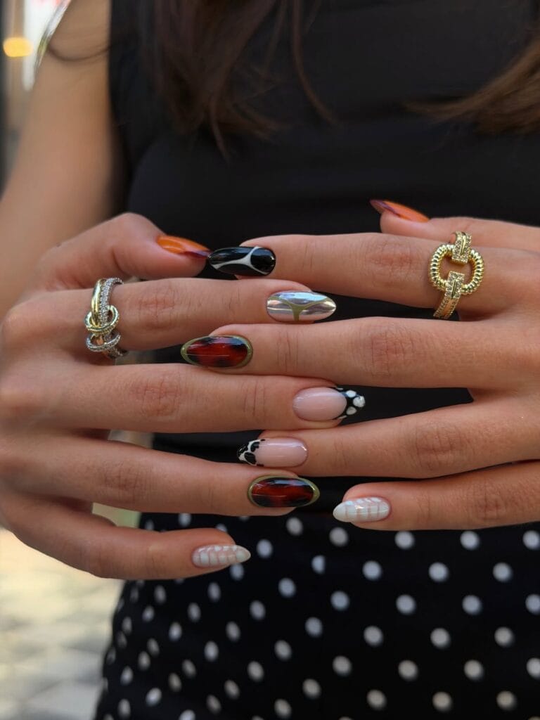 Fall nail designs with tortoiseshell, silver chrome, black accents, white sweater art, and nude nails.
