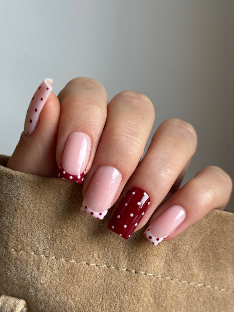 Square fall polka dot nails with pink bases, berry and white French tips, and contrasting dotted accent nails.
