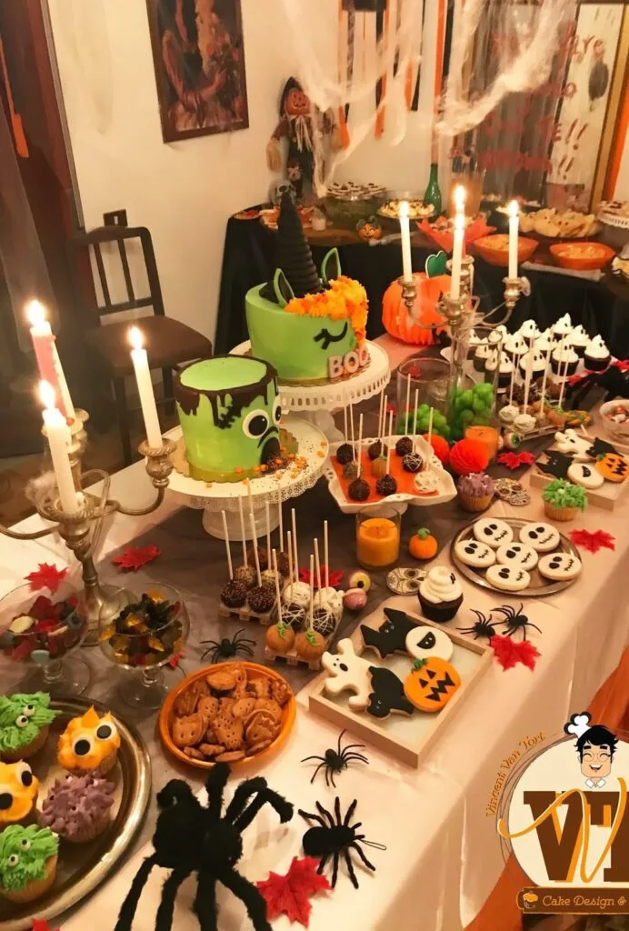 Halloween dessert table with monster cakes, ghost treats, cookies, cupcakes, and candles
