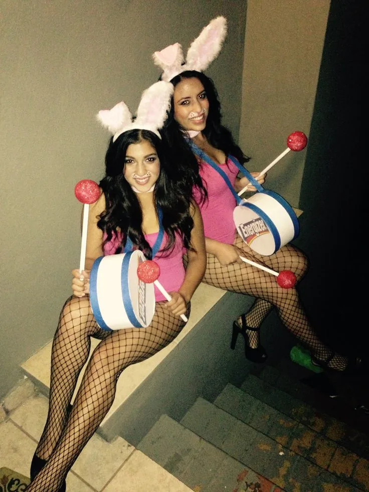 Best friend bunny costumes with pink bodysuits, ears, fishnets, and matching drums labeled “Energizer”.