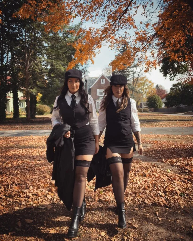 Peaky Blinders best friend Halloween costumes with flat caps, waistcoats, ties, mini skirts, and stockings.