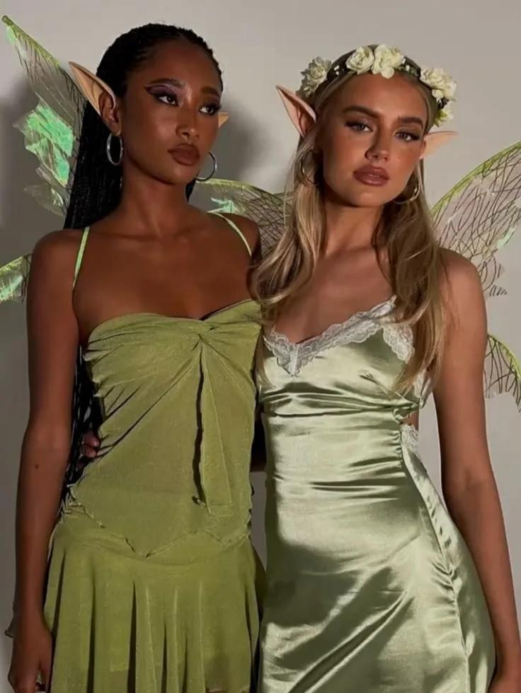 Best friend fairy costumes with green dresses, pointed ears, translucent wings, and a white flower crown.