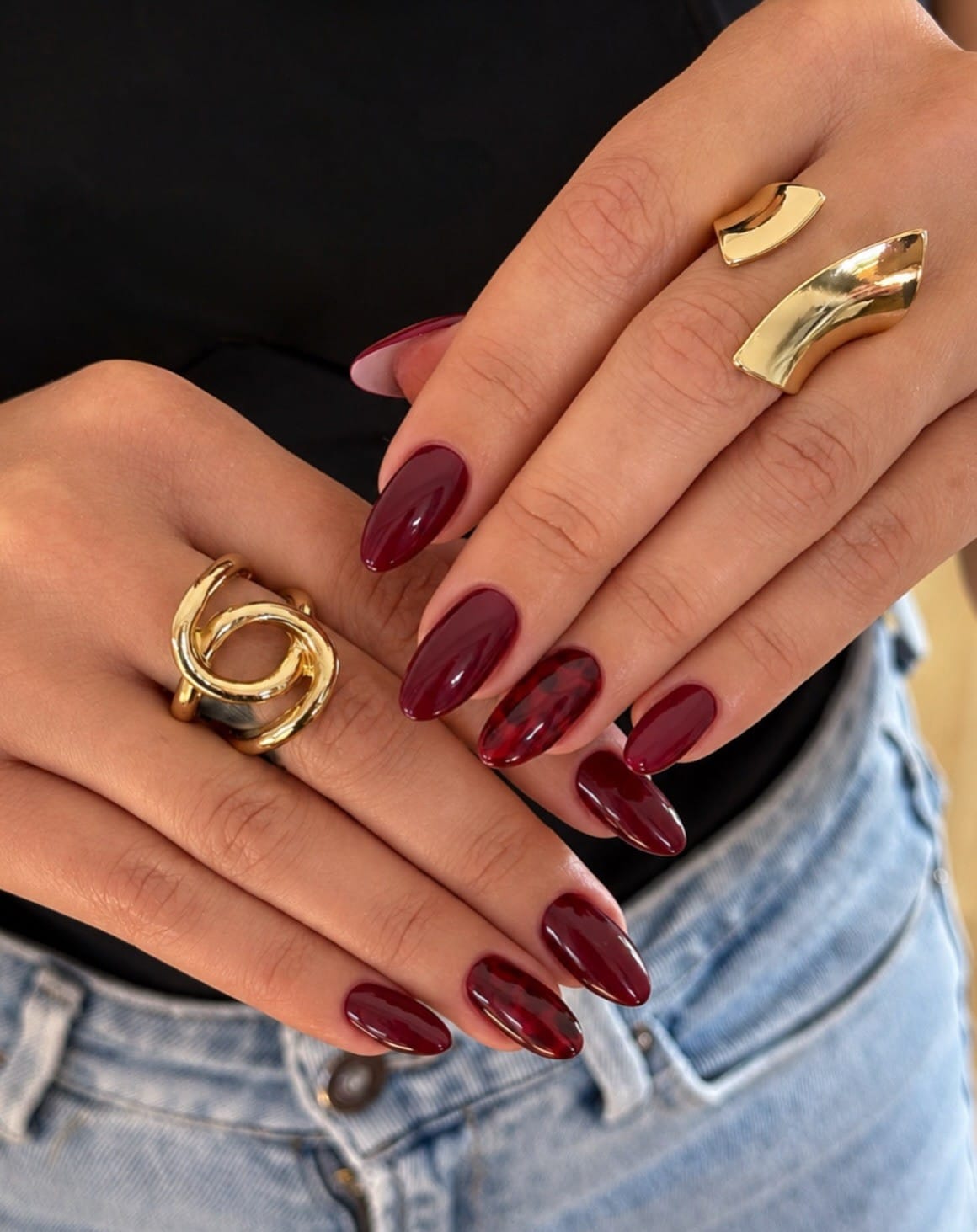 Almond fall nails in glossy merlot burgundy with burgundy tortoiseshell accent nails