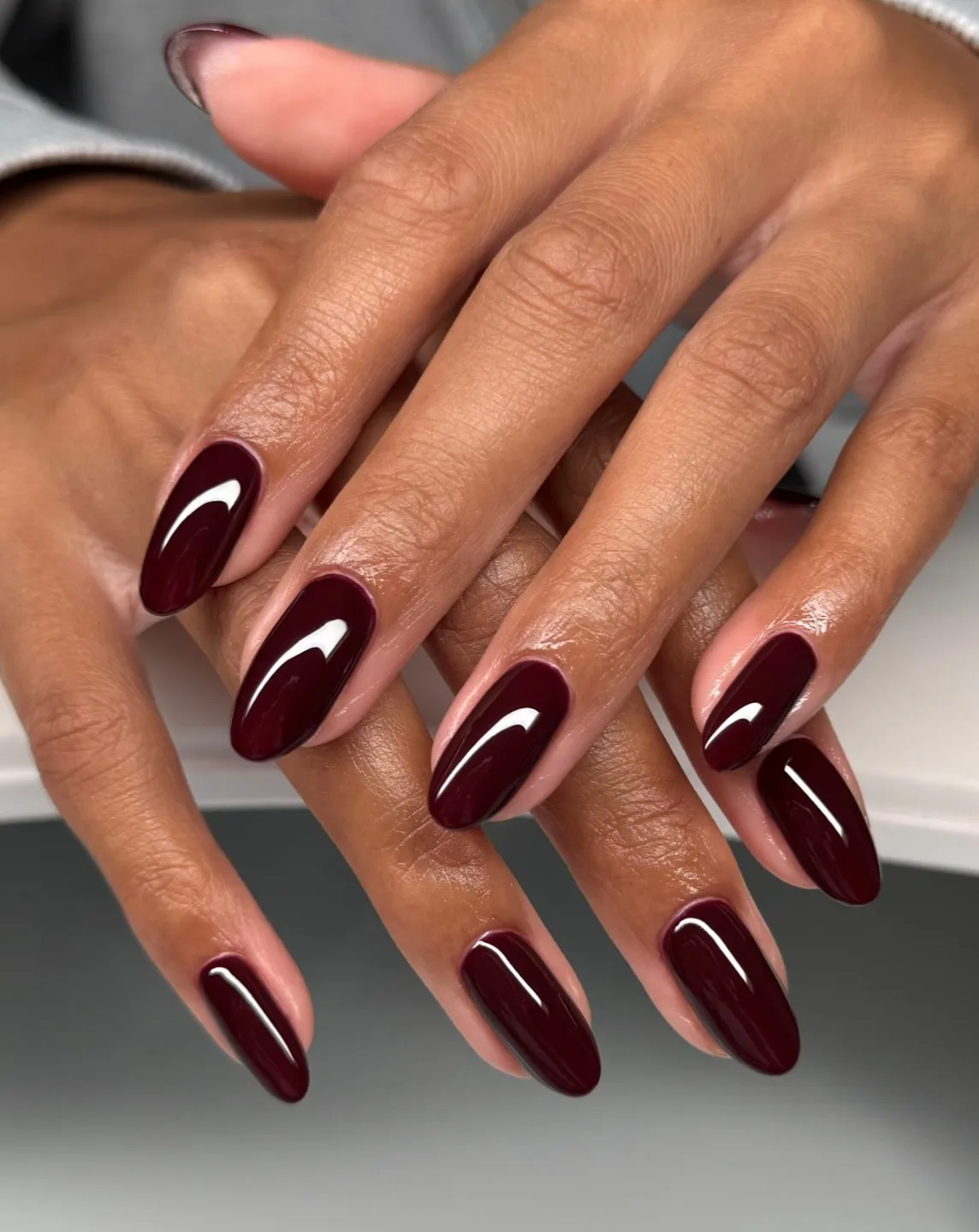 Almond autumn nails in deep merlot burgundy with a high-shine finish