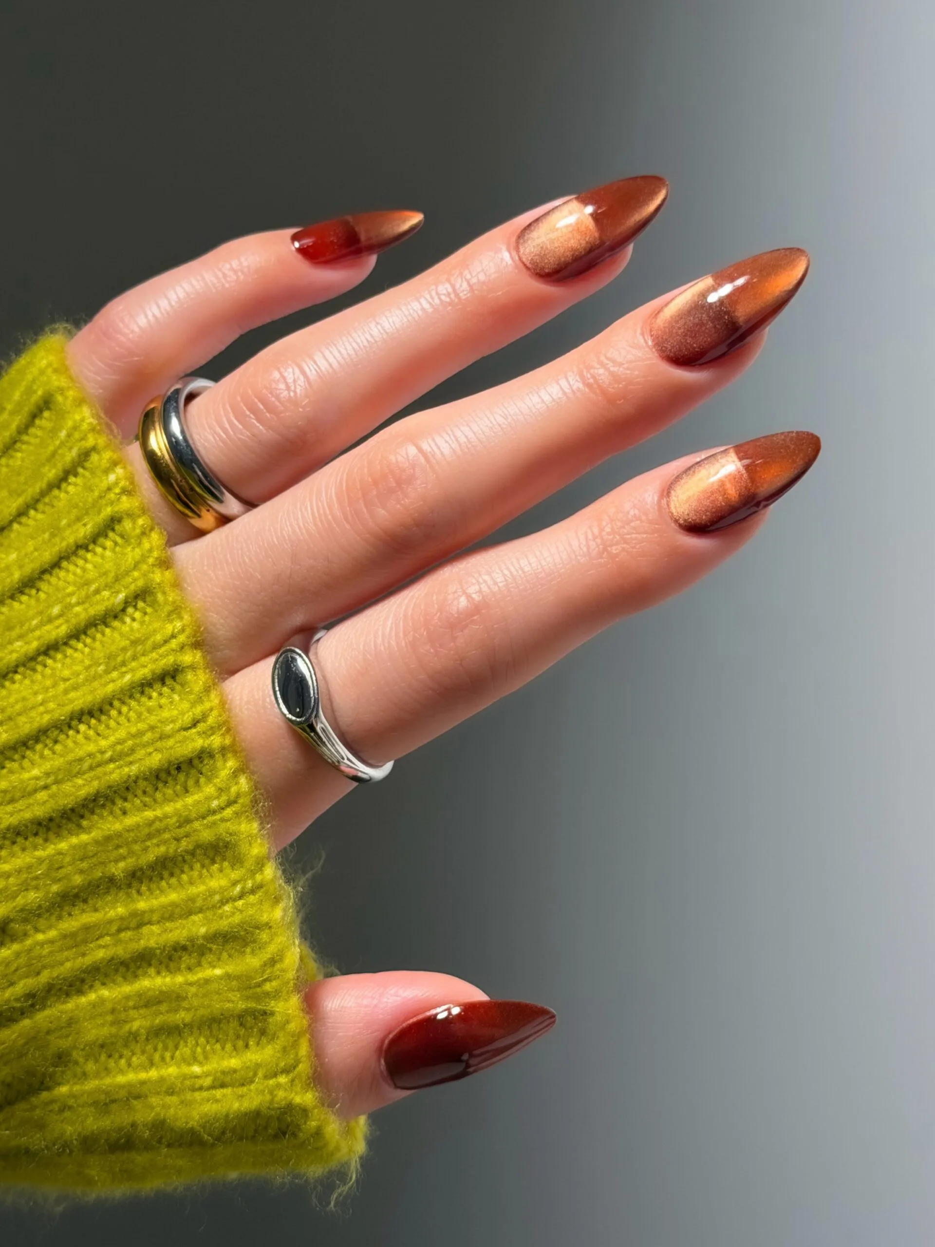 Almond fall nails in copper cat-eye velvet blending into deep red-brown tips