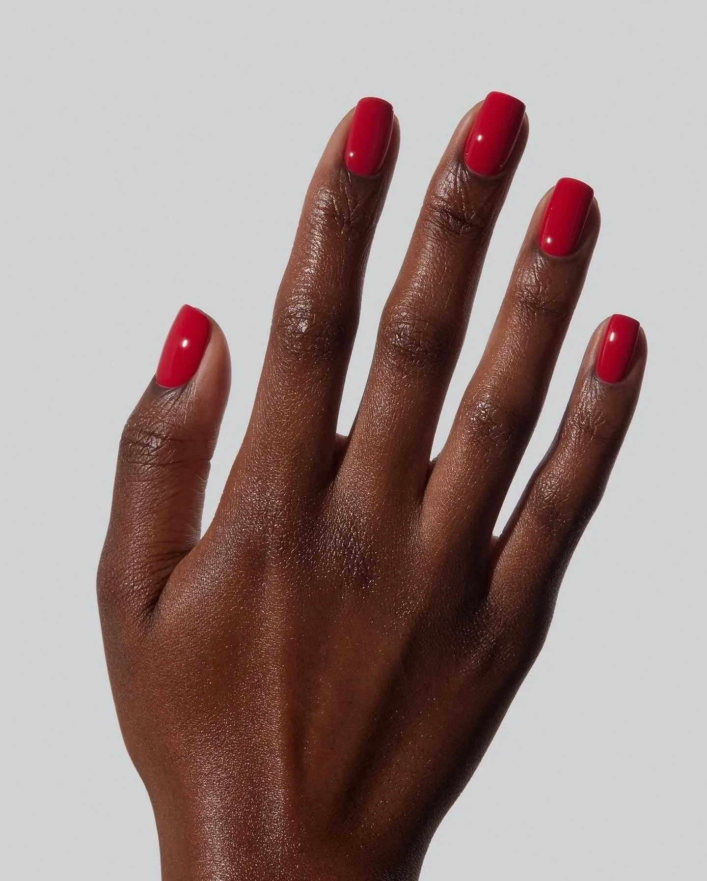Short square November nail colors in glossy poppy red