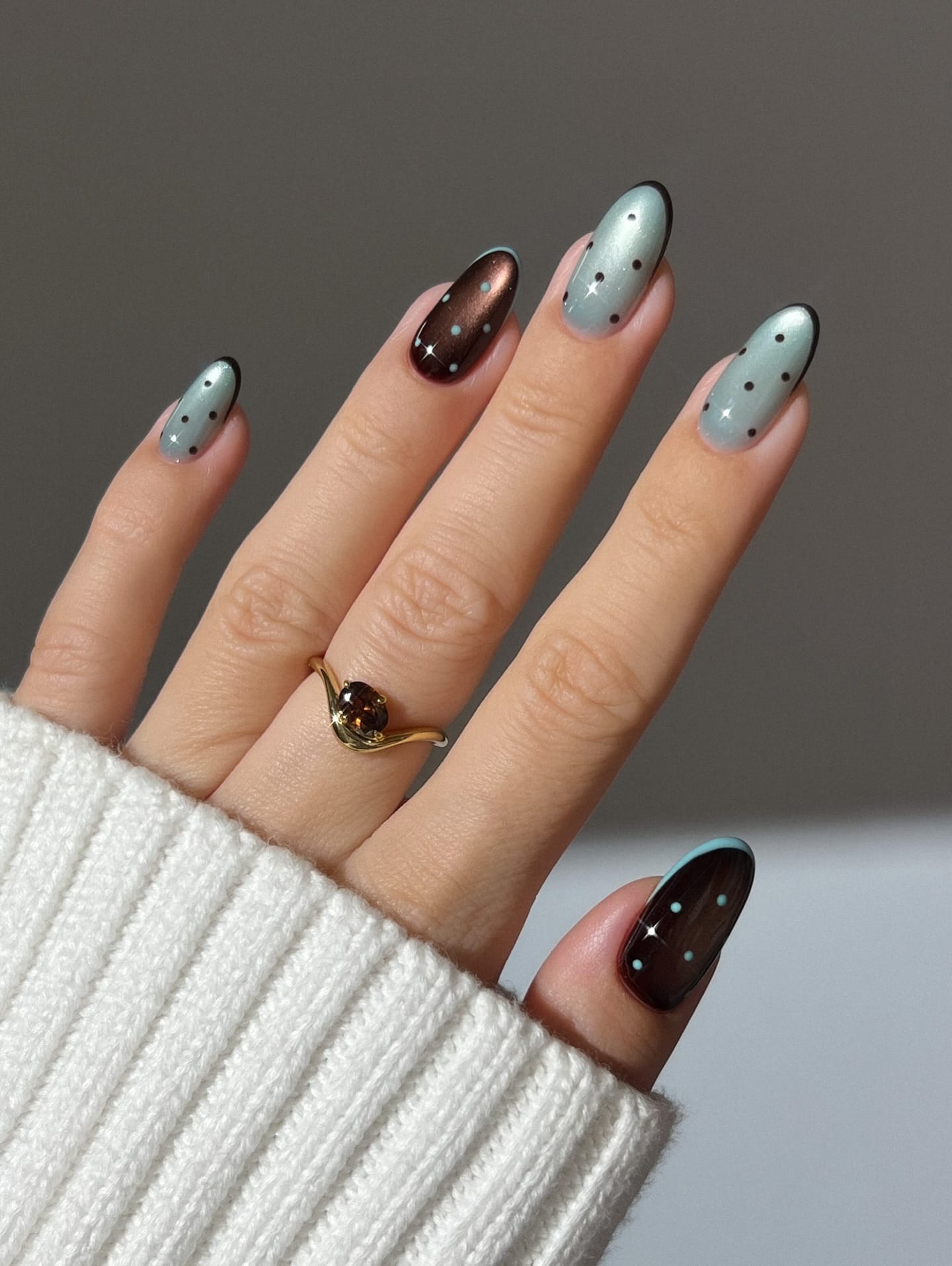 Almond November nails mixing powder blue and chocolate brown polish with contrasting star accents
