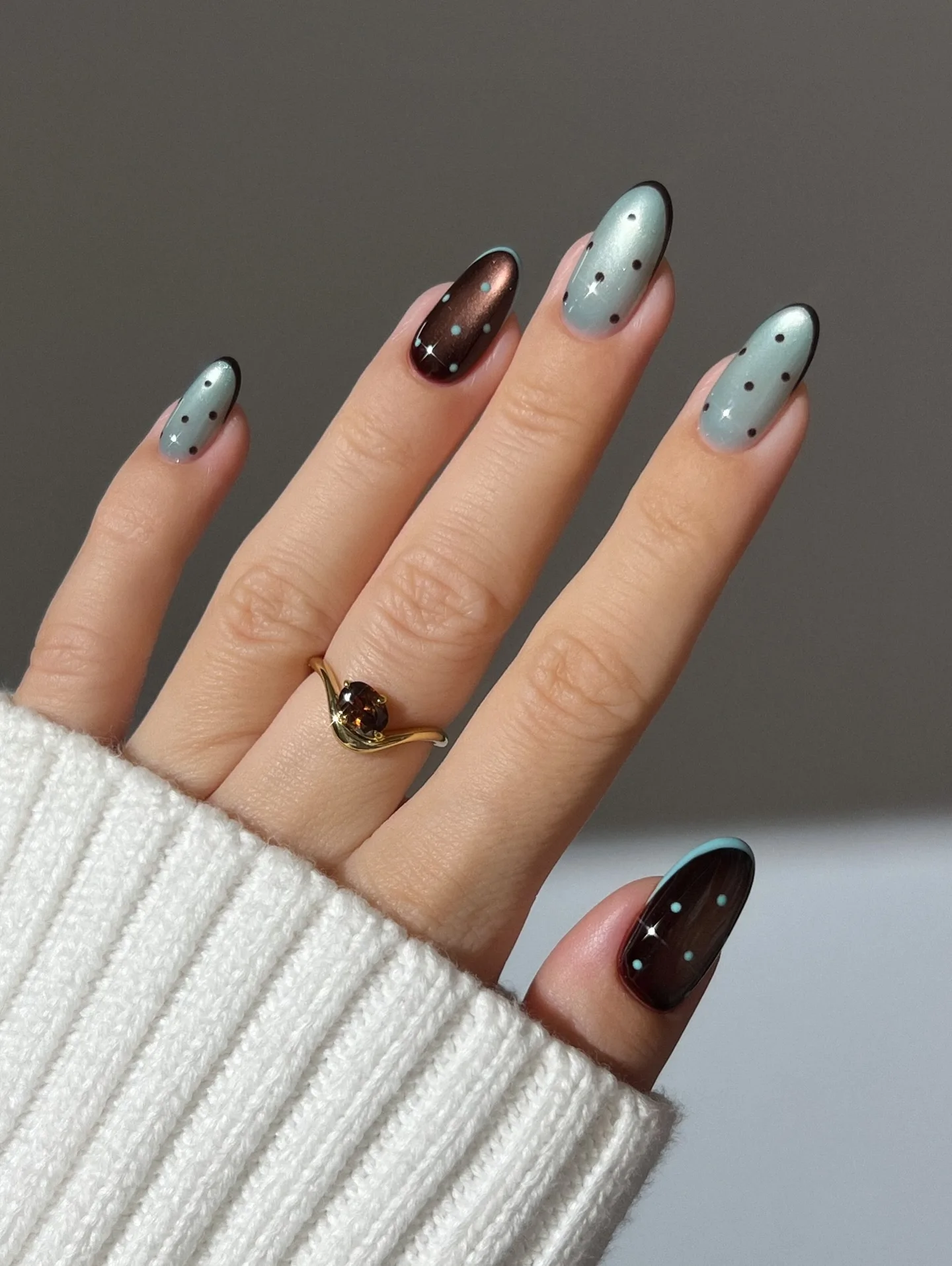 Almond November nails mixing powder blue and chocolate brown polish with contrasting star accents