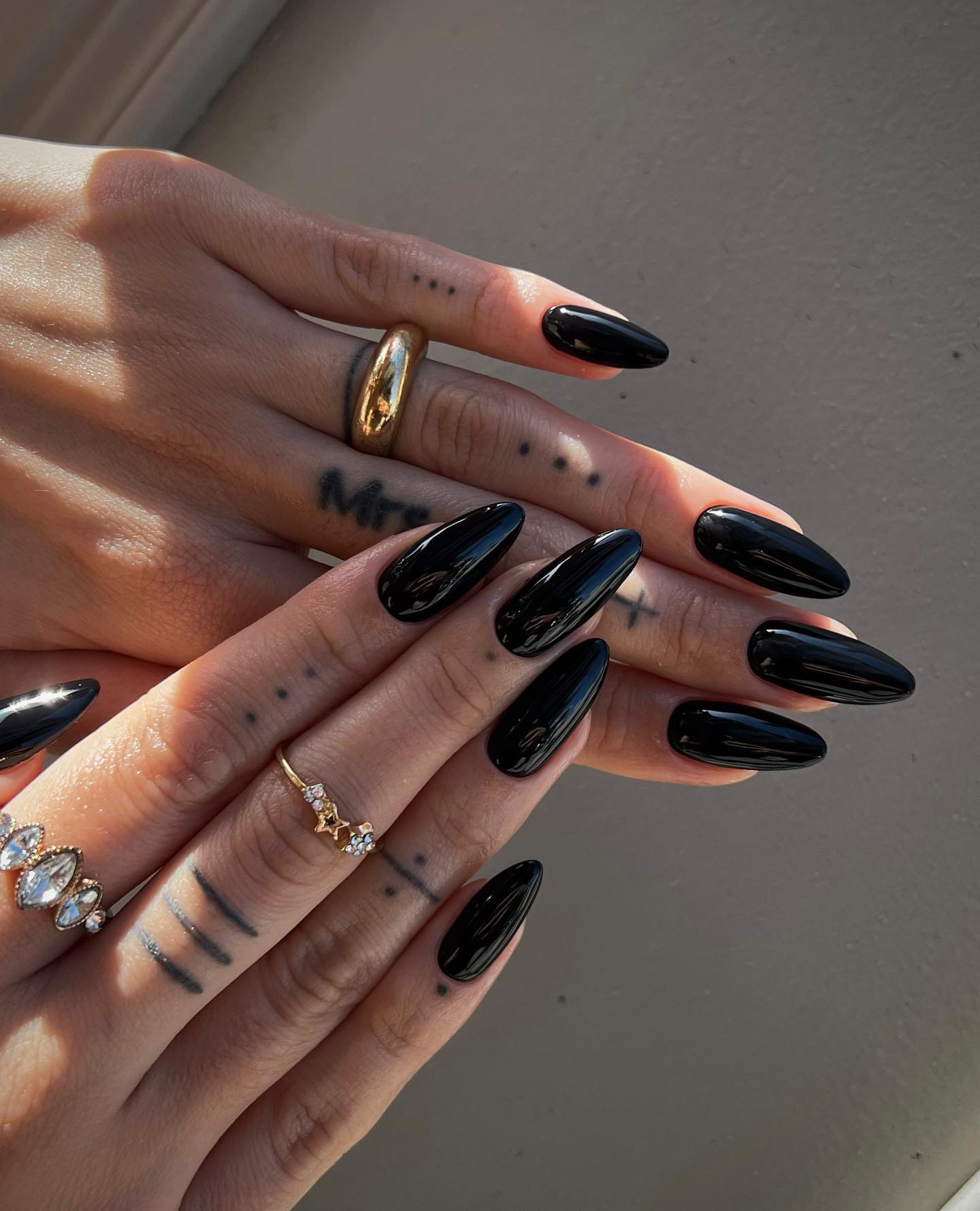 Long almond fall nails in high-shine solid black polish