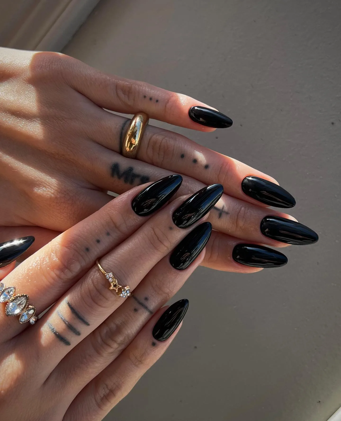 Long almond fall nails in high-shine solid black polish