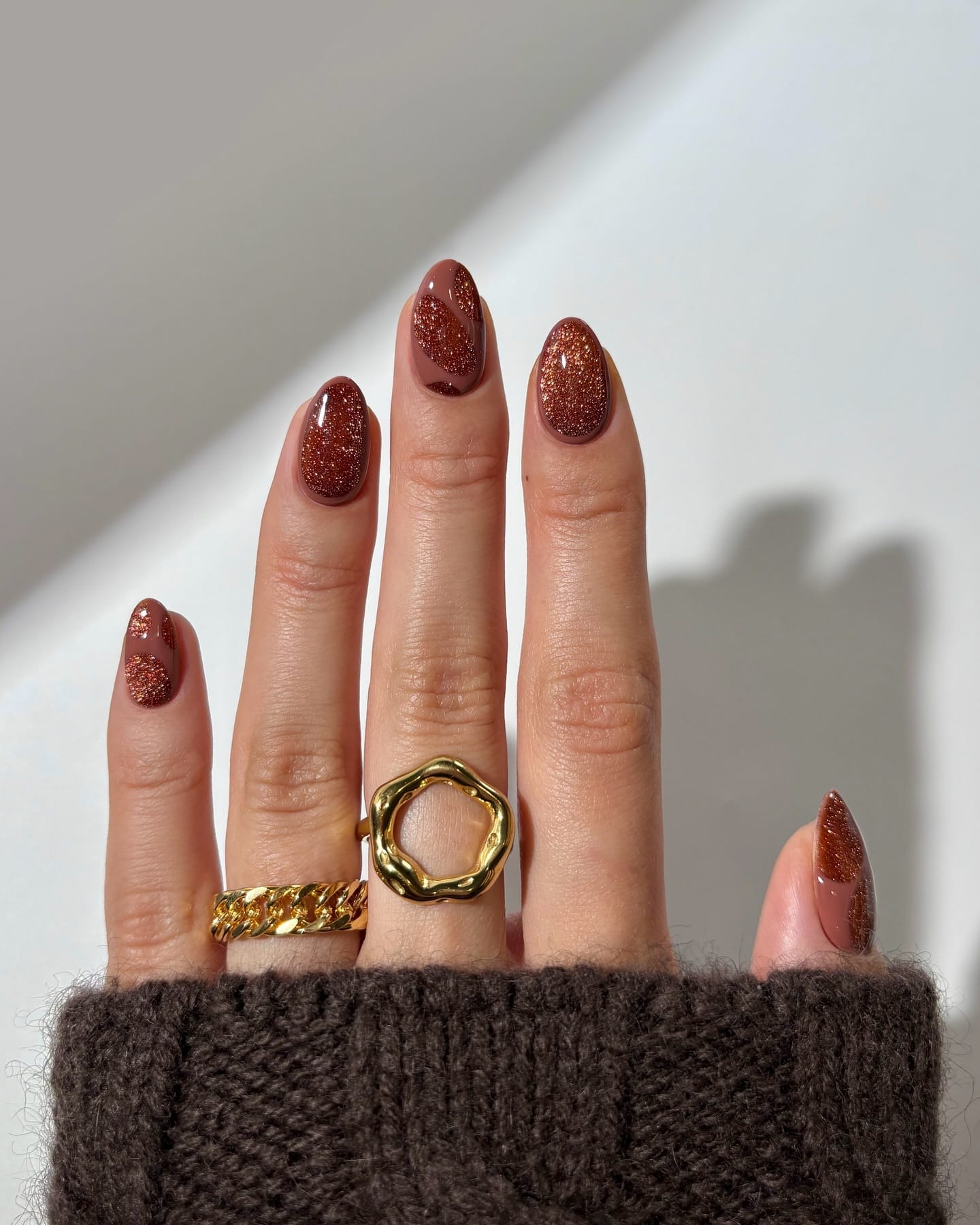 Oval autumn nails in cocoa brown cream with copper glitter shapes and full glitter accent nails