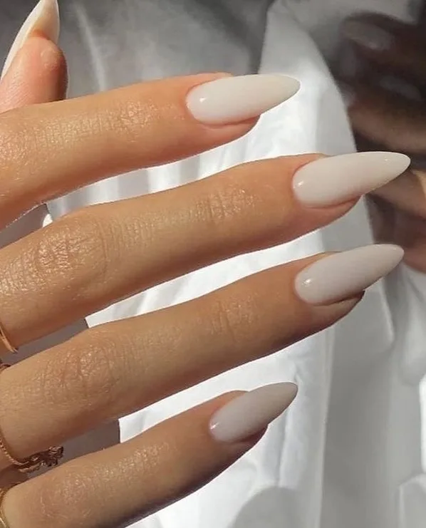Long almond fall nails in solid milky ivory polish with a soft cream finish