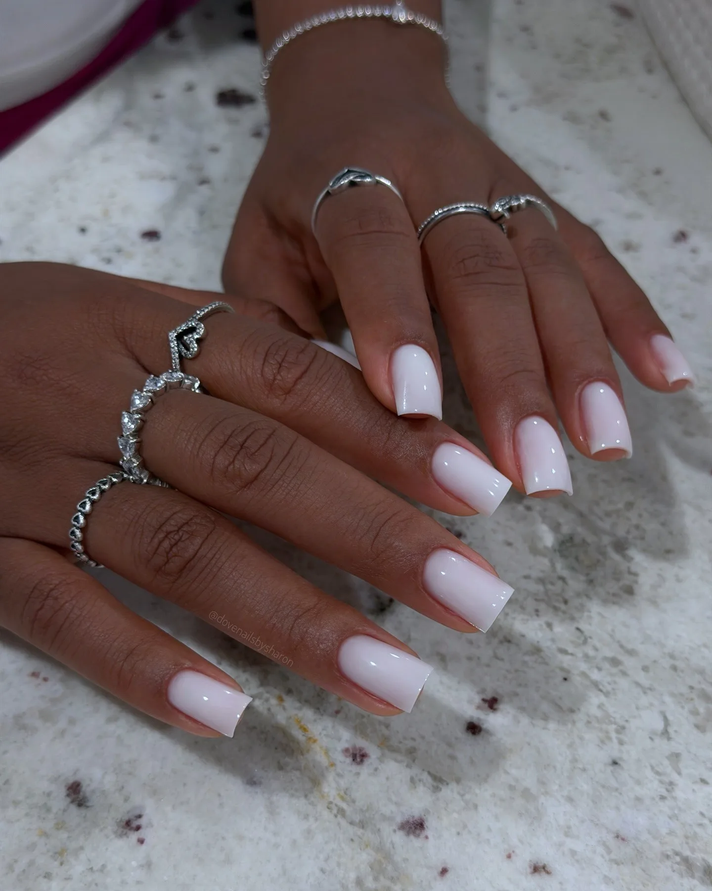 Short square November nails in sheer milky white polish with a glossy shine